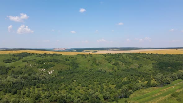 Aerial Landscape View of Yellow Cultivated Agricultural Field with Dry Straw of Cut Down Wheat After