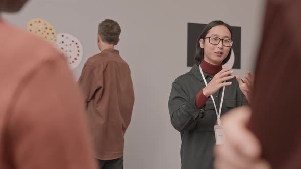 Tourists Listening to Guide in Contemporary Art Museum