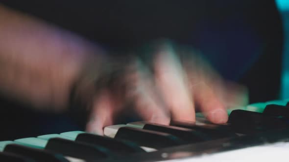 Hands of Pianist or Keyboardist of a Rock Band Close Up Playing a Synthesizer