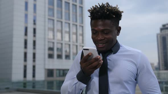 Dark-skinned Businessman Chatting Online on Phone