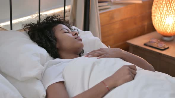 Uncomfortable Young African Woman Sleeping in Bed 