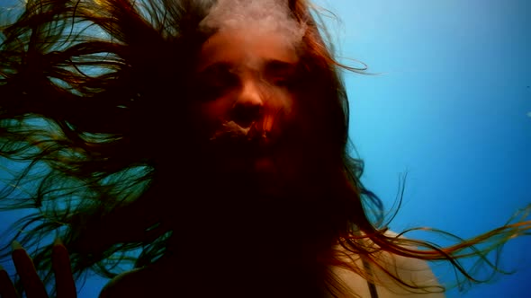 Creepy Portrait of a Woman Underwater Hair in Weightlessness Slow Motion in the Mouth White Liquid