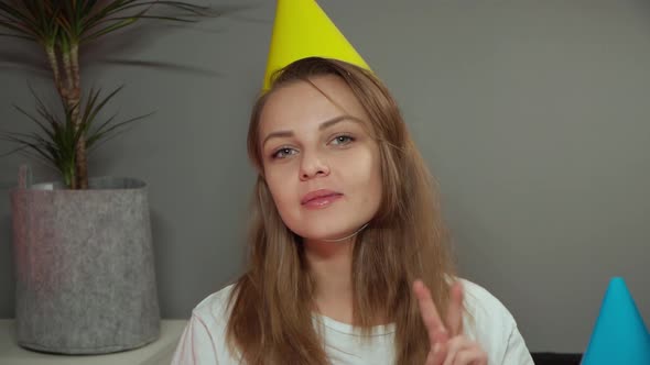 Woman in Birthday Cap Showing Showing Thumbs Up