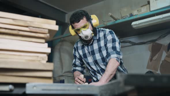 A Man Works with a Planer