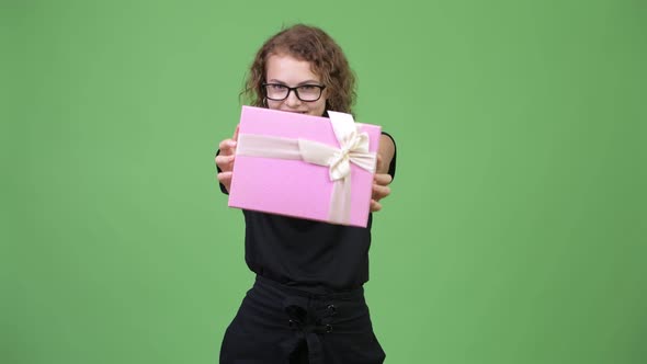 Young Happy Beautiful Nerd Woman Giving Gift Box