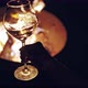 Female Hand Waving Wine in a Glass on Defocused Cozy Camp Fire of Background - VideoHive Item for Sale
