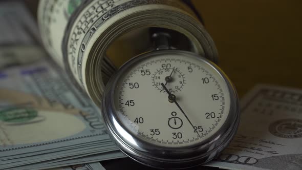 Dollars and stopwatch. Business concept of lost time and failed investments