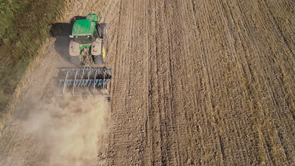 Tractor with Disc Harrows on the Farmland