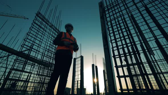 Male Architect Is Looking Around a Building Lot at Sunset