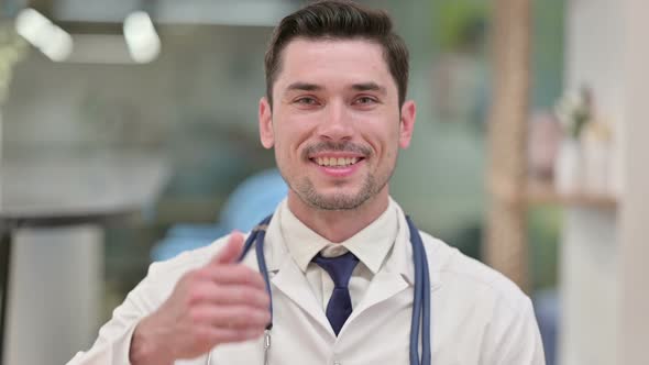 Positive Young Male Doctor Showing Thumbs Up Sign 