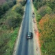Aerial View Of White Car Driving On Country Road - VideoHive Item for Sale