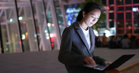 Businesswoman use of notebook computer at night