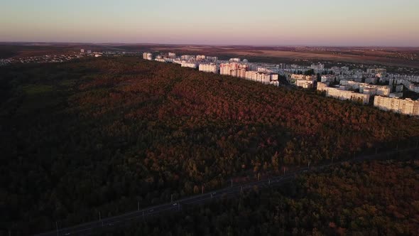 Aerial drone video of beautiful cityscape at sunset in autumn season