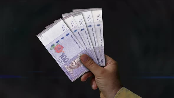 Malaysia Ringgit money fan of banknotes in hand