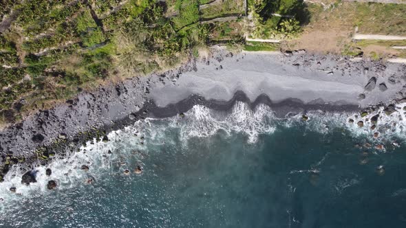 A top down view of the waves coming in to shore in Ponta Do Sol, Madeira. Shot on DJI.