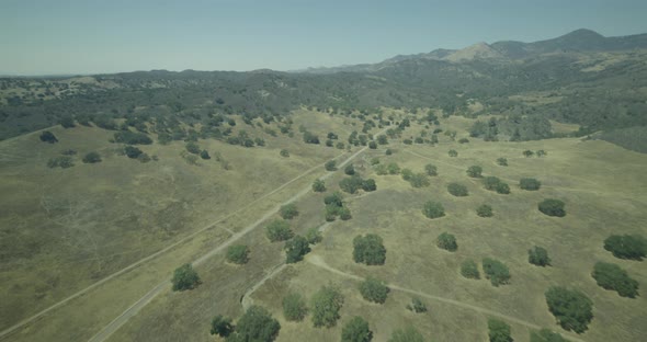 Helicopter aerial slowly zooming closer to suburban landscape, overcast day