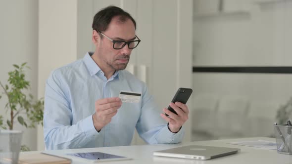 Middle Aged Man Having Online Payment Success on Smartphone