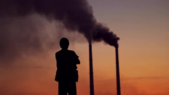 Silhouette of a man on the polluted air background.