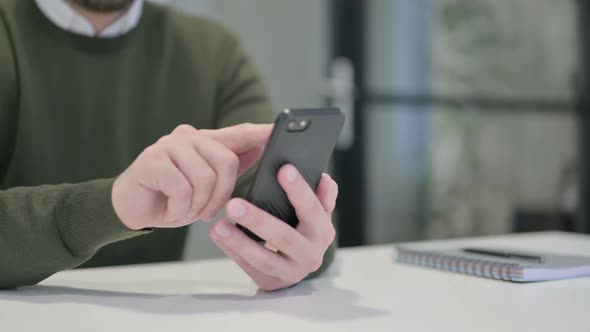 Close Up of Young Businessman Using Smartphone