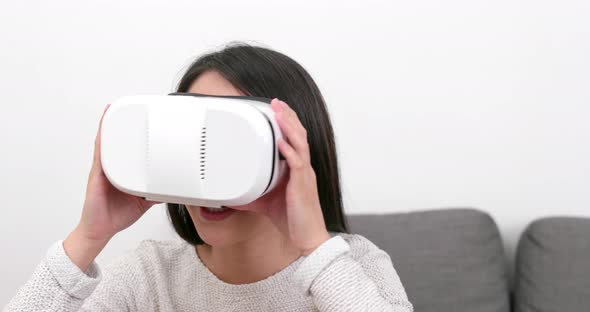 Woman looking with VR device at home