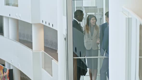 Office Workers Going Up in the Elevator