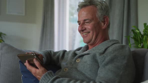 Animation of happy caucasian senior man using smartphone at home