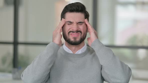 Portrait of Young Man Having Headache