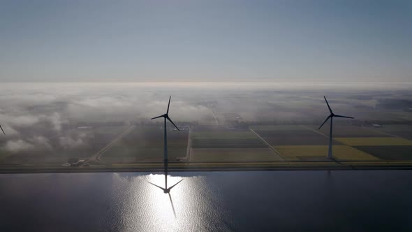 Offshore Windmill Park with Clouds and a Blue Sky Windmill Park in the Ocean Drone Aerial View with