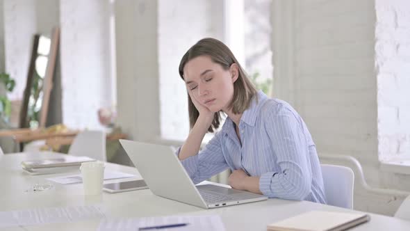 Tired Young Woman Having Quick Nap in Modern Office