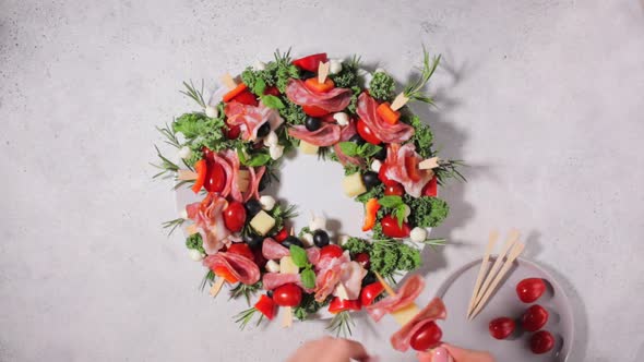 Christmas wreath of festive appetizer. Canapes with cheese, vegetables and ham. 