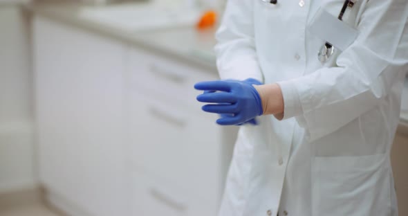 Close Up of Female Doctor Wearing Gloves