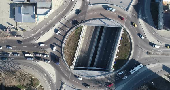 Top down view round road junction in the center. Circle road on two levels. Street traffic