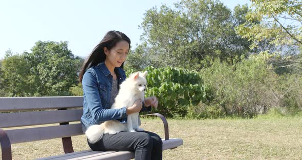 Woman play with her dog at and sitting at outdoor park