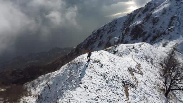 Hiker on top of the snowy mountain ridge, Monte Barro, Lecco, Italy