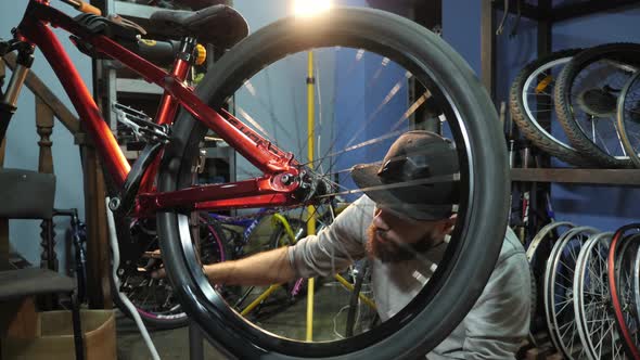 Man checking the bike wheel