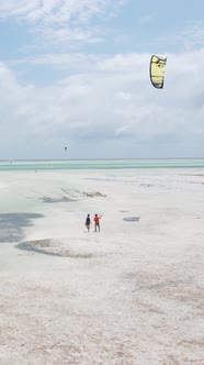 Vertical Video Kitesurfing Near the Shore of Zanzibar Tanzania