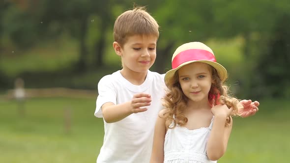 Little Boy Closes His Eyes To the Girl with His Own Hands. Slow Motion