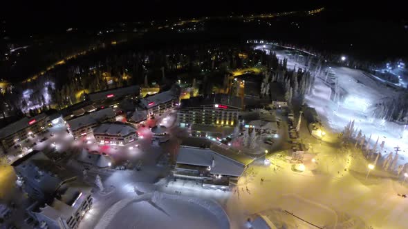 Flying over winter resort at night, Finland