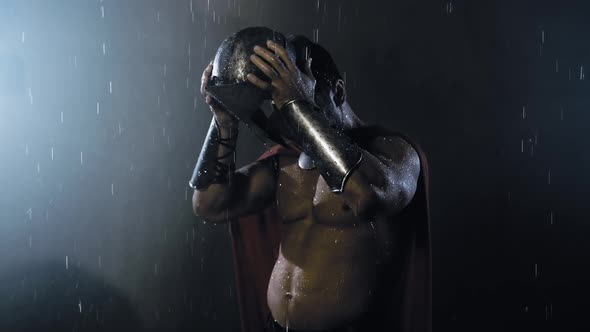 Shirtless Wet Spartan Wearing Helmet.