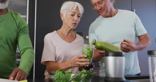 Happy senior diverse people cooking in kitchen at retirement home