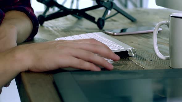 A Caucasian Male Typing on a Wireless Keyboard 15