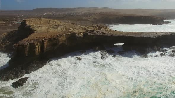 Aerial view of waves crashing of the rocks of punta Guadalupe in Fuerteventura.