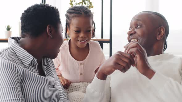 Adult Middleaged African Man Father Grandfather Counting on Fingers and Young Afro Black Woman