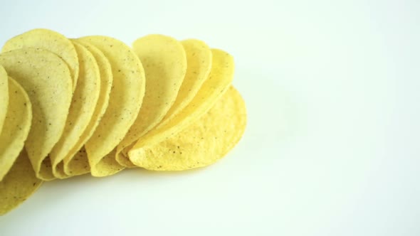 Yellow corn taco shells on a white background.