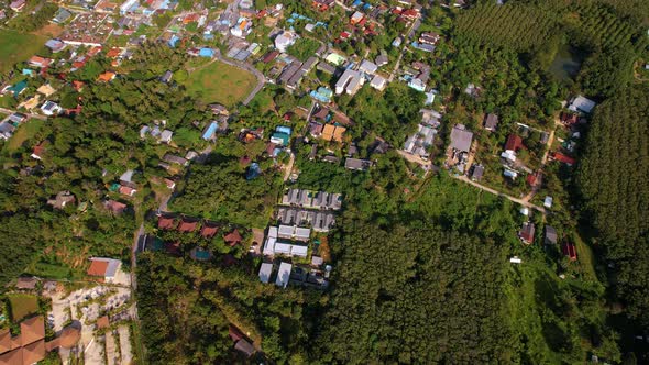 Aerial View of a Village Among the Jungle with Roads Houses Villas Hotels on Phuket Island Thailand