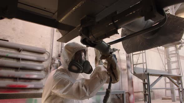 Closeup of the Face of a Woman in a Mask with a Respirator Who Works in the Paint Shop