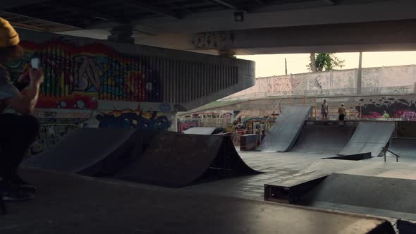 Hipster Man Taking Photo on Mobile Phone of Skate Park