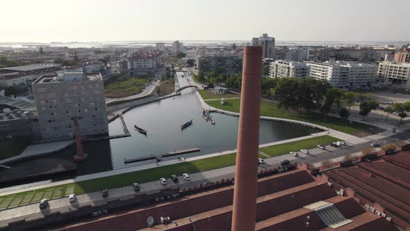 Old factory chimney and majestic cityscape of Aveiro in Portugal, aerial orbit view