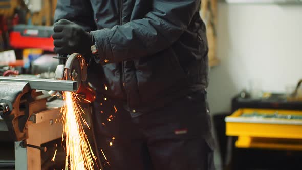 Angle Grinder Cutting Metal at Workshop