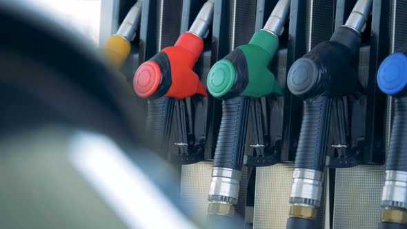 Gas Station with a Fuel Nozzle Being Taken Out From the Gas Pump. Gasoline Fuel, Gas Station Concept